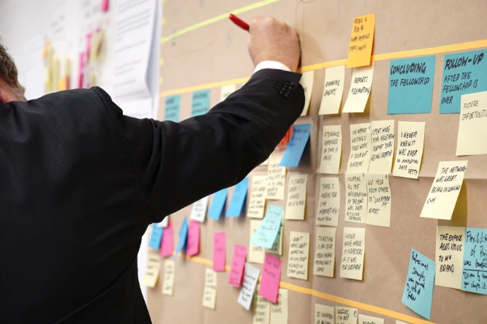 working on kanban view of project tasks on corkboard